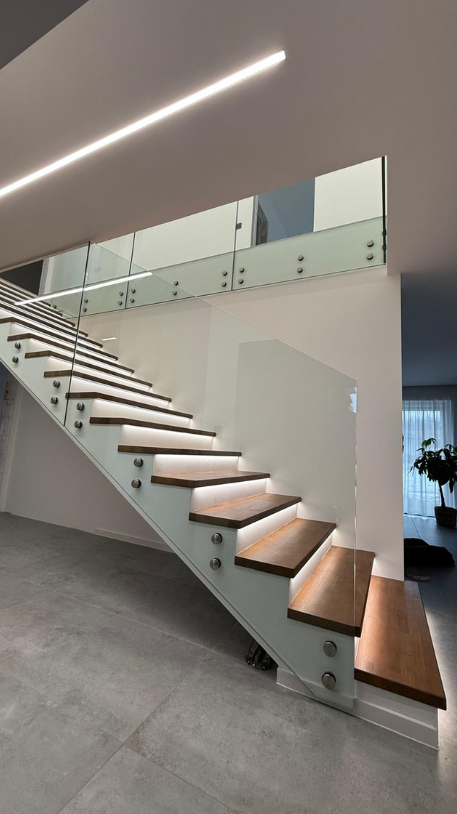 Dřevěný obklad schodiště s celoskleněným zábradlím